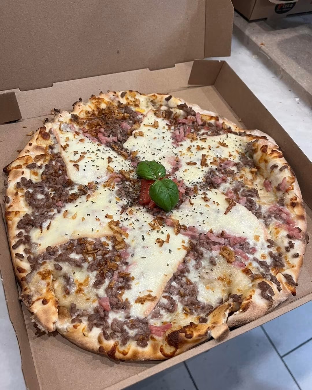 Pizza généreuse au fromage fondant servie dans sa boîte